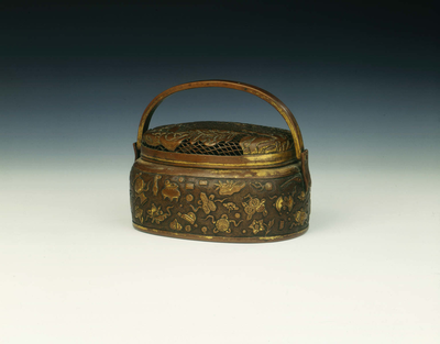 Gilt copper hand warmer with landscape design and