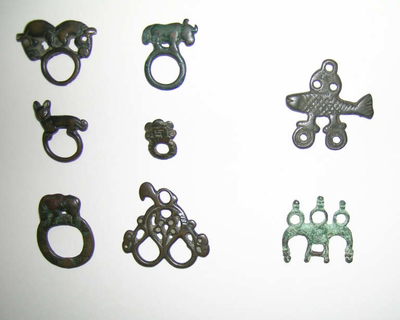 Six bronze ring ornaments surmounted by animals -