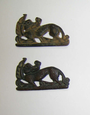 Two openwork belt plaques of wolflike