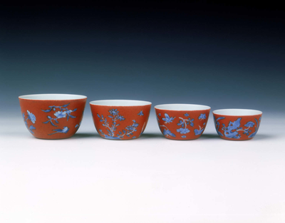 Set of four graduated wine cups on coral