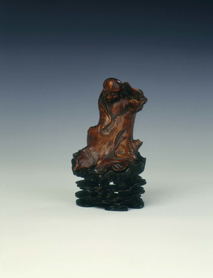 Wood figure of a luohan wrapped in a treeLate