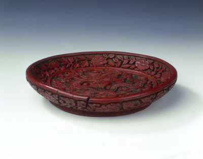 Carved red lacquer saucer with dragon amid clouds