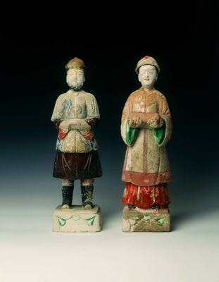 Pottery figures of a mandarin and lady
