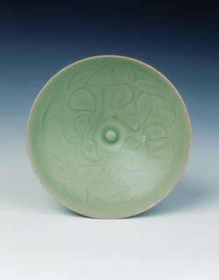 Celadon bowl with carved floral design
Late
