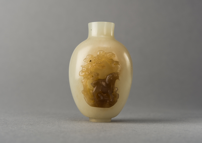 Jade snuff bottle with raised carving of animal