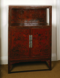 A red lacquer display cabinet with 18th century