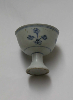 Blue and white stem cup with floral scrolls